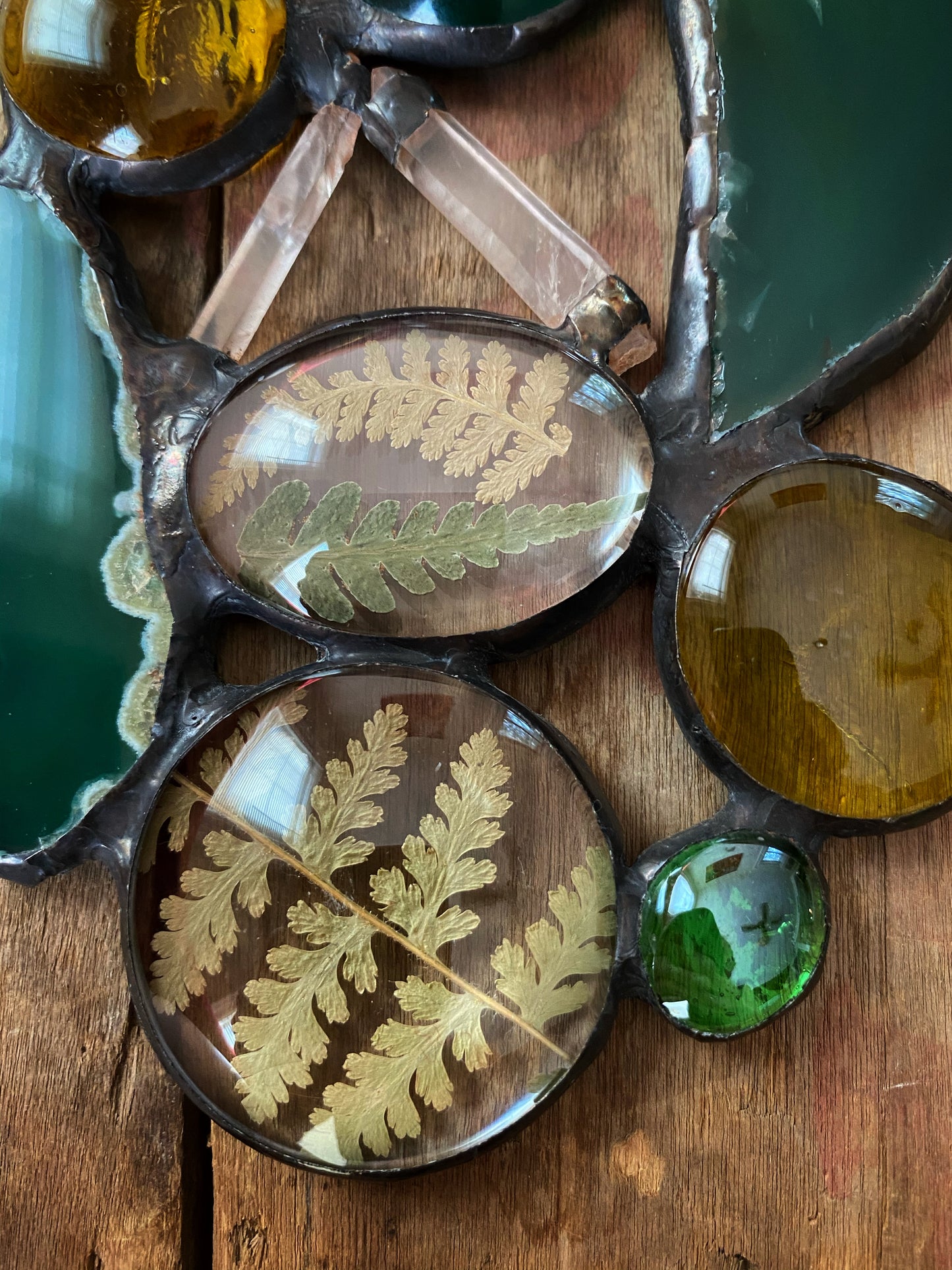 Glass art with pressed ferns, quartz crystals and agate slices.