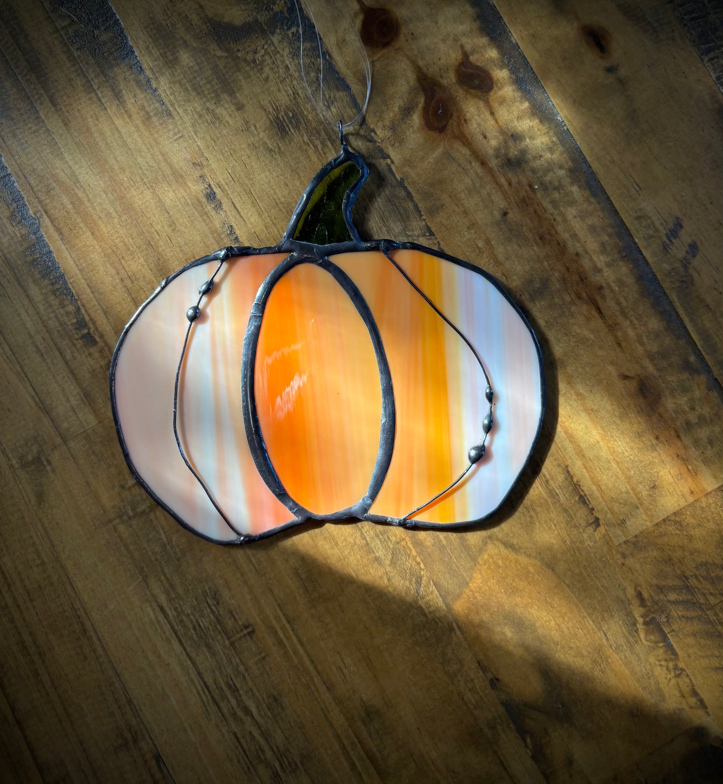 Decorative lamp with striped design on a wooden surface.